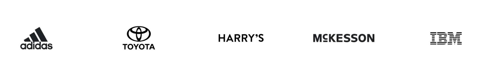 Customer logos of popular companies like IBM, Toyota, and Adidas on a landing page by Survey Monkey.